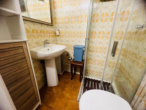 a small bathroom with a sink and a shower at Suite Brescia 10 - Sanremo in Sanremo