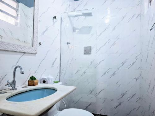 a white bathroom with a sink and a toilet at Copacabana Way - 4 Hóspedes, Praia e Privativo in Rio de Janeiro