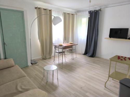 a living room with a couch and a table at Résidence les Sources in Prats-de-Mollo-la-Preste