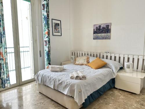 a bedroom with a bed with two towels on it at Casa della Nonna - Art & Vintage Rooms in Noicattaro
