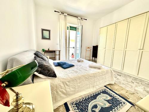 a white bedroom with a bed and a window at Casa della Nonna - Art & Vintage Rooms in Noicattaro