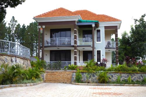 a house with a porch and a balcony at Masindi Serenity Residency in Masindi