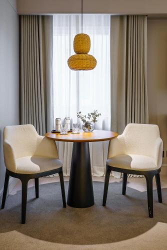 a table and two chairs in a room at Casa Lucia Member of Melia Collection in Buenos Aires