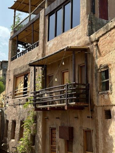 an old building with a balcony on the side of it at نزل حارة المسفاة Harit AL Misfah Inn in Misfāh
