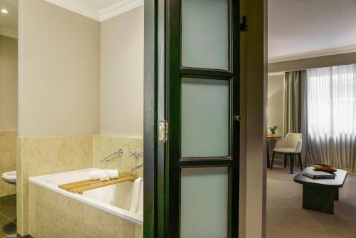 a bathroom with a bath tub in a room at Casa Lucia Member of Melia Collection in Buenos Aires