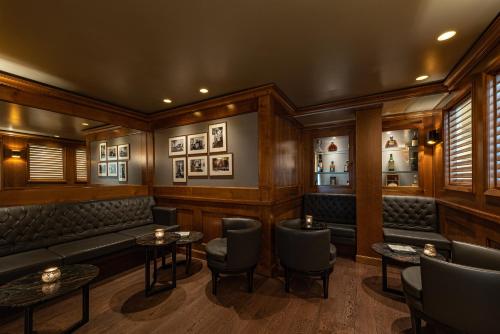 a bar with wooden walls and chairs and tables at Colombi Hotel in Freiburg im Breisgau