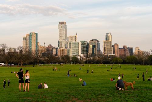 a group of people in a park with a city in the background at Wyndham Garden Hotel Austin in Austin