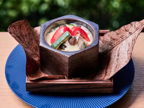 a chocolate dessert on a blue plate on a table at Atami Izusan Karaku in Atami