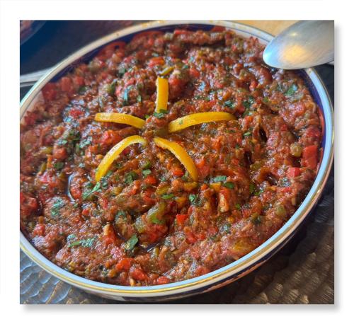 a dish of chili with peppers on top of it at Riad Dar Baraka Rabat in Rabat