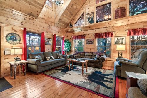 a living room with wooden walls and furniture in a cabin at Whisper Ridge in Cartertown