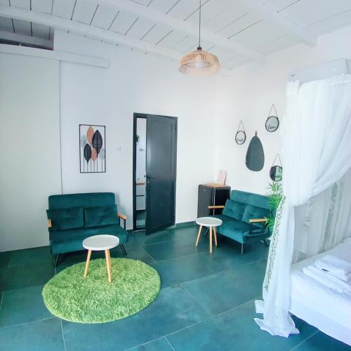 a living room with a couch and two chairs and a table at Sunshine Bungalow in Schitul