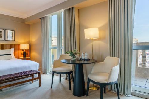 a hotel room with a bed and a table and chairs at Casa Lucia Member of Melia Collection in Buenos Aires