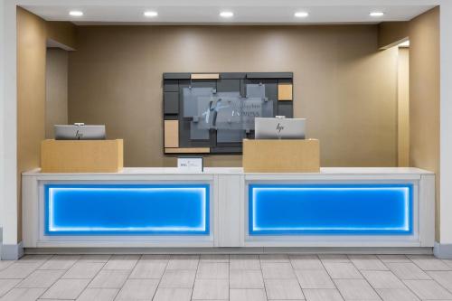 a waiting room with blue counters in a building at Holiday Inn Express Augusta Downtown by IHG in Augusta