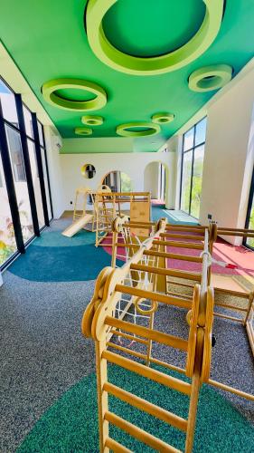 a room with several bunk beds and a green ceiling at Jungle Guardian - Rooftop Pool & Beach Club in Zona Hotelera Tulum in Tulum
