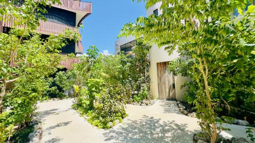 a building with trees in front of it at Jungle Guardian - Rooftop Pool & Beach Club in Zona Hotelera Tulum in Tulum