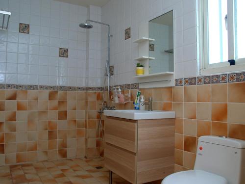 a bathroom with a sink and a toilet at Let's Play B&B 七桃旅宿 in Nanwan