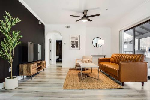 a living room with a couch and a table at Boulevard Stays 2BR by Stadium Pool Parking Gym 05 in Glendale
