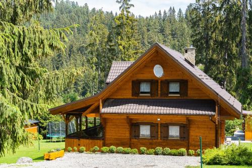 a wooden house with a gambrel roof at Chata Janka in Závažná Poruba