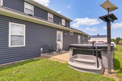 a boat sitting in the yard next to a house at Quiet Kentucky Vacation Rental with Hot Tub in Berry