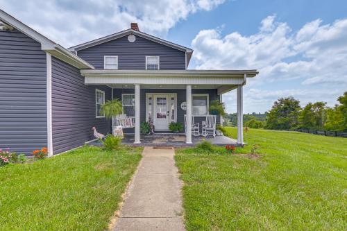 a gray house with a porch and lawn at Quiet Kentucky Vacation Rental with Hot Tub in Berry