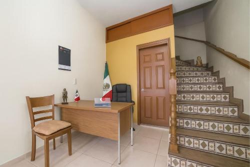 a room with a desk and a staircase at Casa Santa Fe in Guanajuato