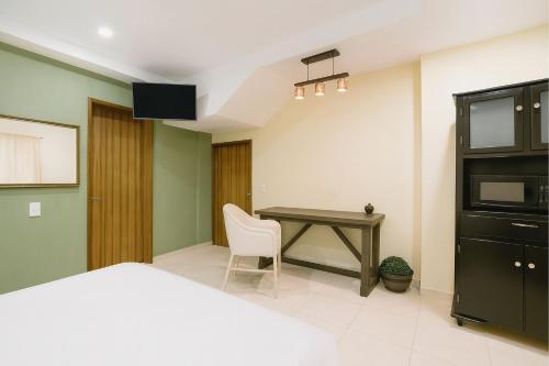 a bedroom with a desk and a bed and a table at Casa Santa Fe in Guanajuato