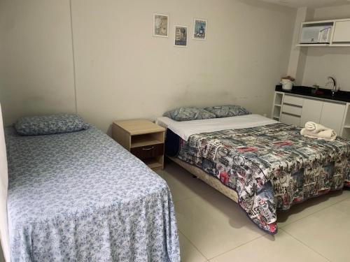 two beds in a small room with at stúdio ap102 - para casal com filho in Jaraguá do Sul