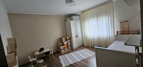 a small room with a bed and a window at Casa Maxim - relaxare în verde in Pantelimon