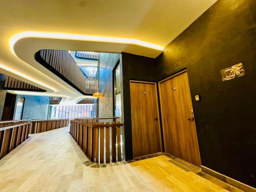 a hallway of a building with a staircase and a ceiling at Jungle Guardian - Rooftop Pool & Beach Club in Zona Hotelera Tulum in Tulum