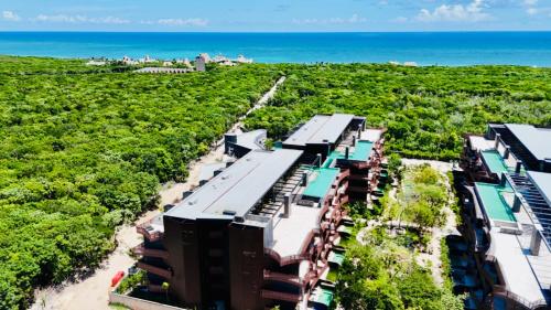 an aerial view of a resort near the beach at Jungle Guardian - Rooftop Pool & Beach Club in Zona Hotelera Tulum in Tulum
