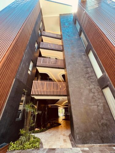 an external view of a building with balconies at Jungle Guardian - Rooftop Pool & Beach Club in Zona Hotelera Tulum in Tulum