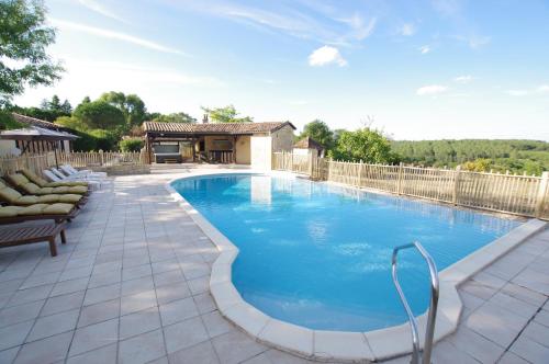 a swimming pool in a backyard with a fence at Les gîtes du Hameau du Jardin Fleuri in Bosset