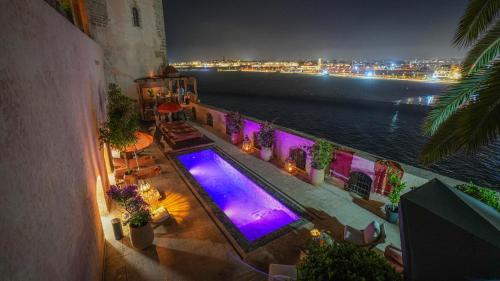 an overhead view of a swimming pool at night at Riad Dar Baraka Rabat in Rabat