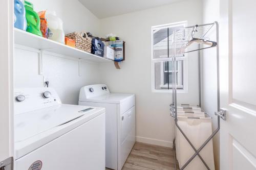 a small white laundry room with a washer and dryer at Spacious 4BR-3BA Cozy and Modern in Elk Grove in Elk Grove