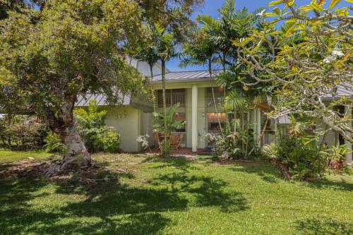 a white house with a tree in the yard at Hale Hana Manao in Princeville