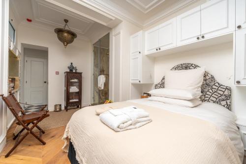 a bedroom with a white bed with towels on it at Riad Dar Baraka Rabat in Rabat