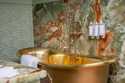 a bathroom with a copper tub in a room at Riad Dar Baraka Rabat in Rabat