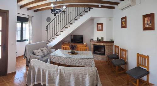 a living room with a table and a fireplace at Casa Corredera in Cumbres Mayores