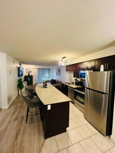 a large kitchen with a stainless steel refrigerator at Mordern 2BedRoom Downtown Apt with Free Parking & Wifi in Edmonton