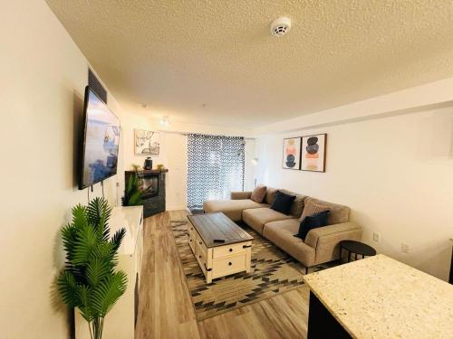 a living room with a couch and a table at Mordern 2BedRoom Downtown Apt with Free Parking & Wifi in Edmonton