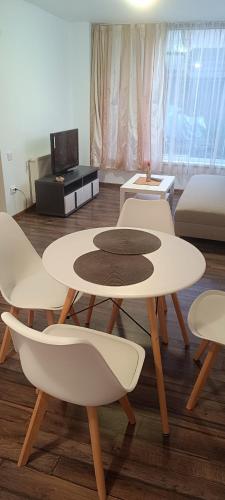 a living room with two tables and a couch at Pensiunea Caramell in Cluj-Napoca