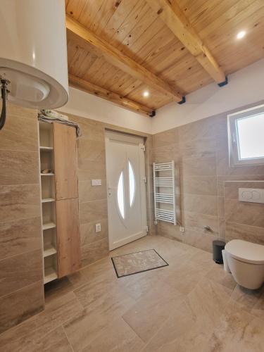 a bathroom with a toilet and a white door at Vila Jela Poličnik in Poličnik