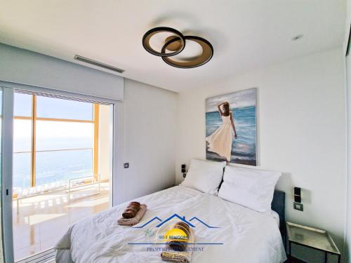 a bedroom with a bed with a painting on the wall at Intempo Golden Magic Sky Resort & Spa in Benidorm