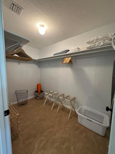 a room with two chairs and shelves on the wall at Wellington Guest Suite in Wellington