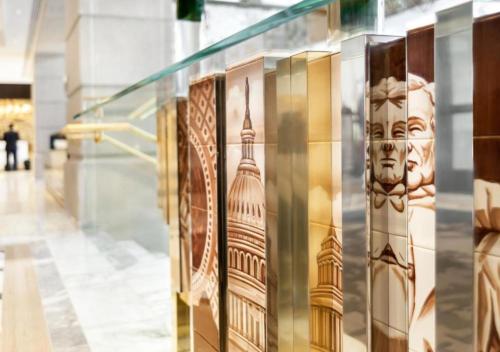 a glass display case in a building with architectural drawings on it at Fairmont Washington DC Gold Experience in Washington