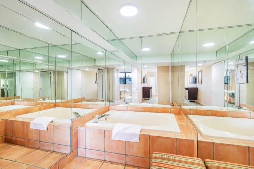 a large bathroom with two sinks and a large mirror at Vacation Village at Bonaventure, Fort Lauderdale in Weston