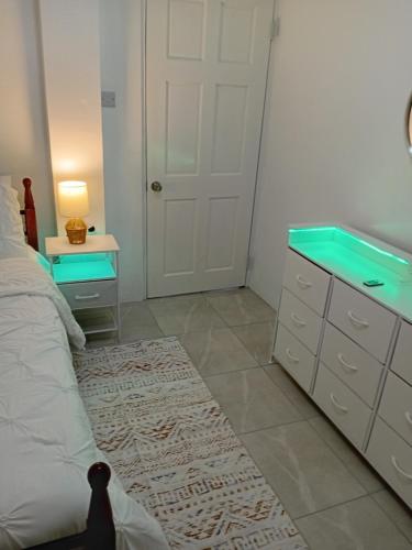a bedroom with a bed and a desk and a mirror at Lawrence Legacy 2 in Saint Georgeʼs