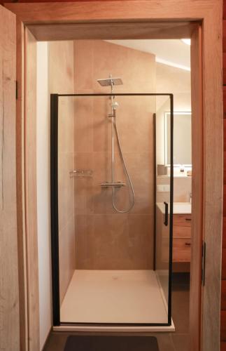 a shower with a glass door in a bathroom at Landhausidylle in Sankt Gilgen
