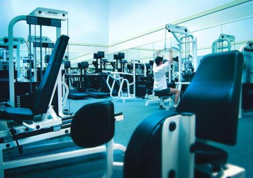 a woman in a gym on a treadmill at Fairmont Washington DC Gold Experience in Washington