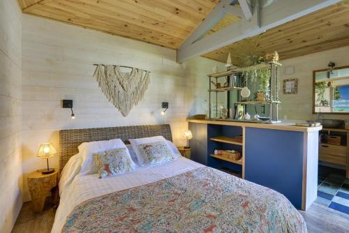 a bedroom with a bed in a room with wooden ceilings at Cap Mango Paradise in Capbreton
